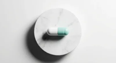 Gros plan iconique d'une capsule de médicament sur fond de marbre blanc