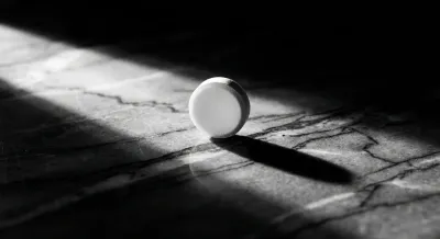 Gros plan minimaliste d'un comprimé sur fond sombre